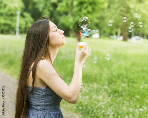 Young Woman Blowing Bubbles
