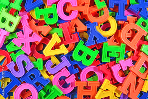 Colorful plastic alphabet letters as background