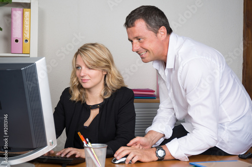 Businesspeople working together on a computer