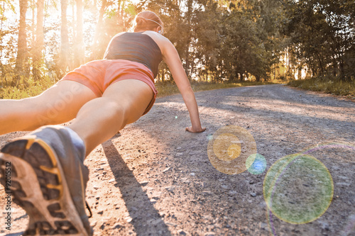 Young sport woman does pushups