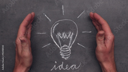 Hands showing idea bulb chalk drawing, stop motion animation