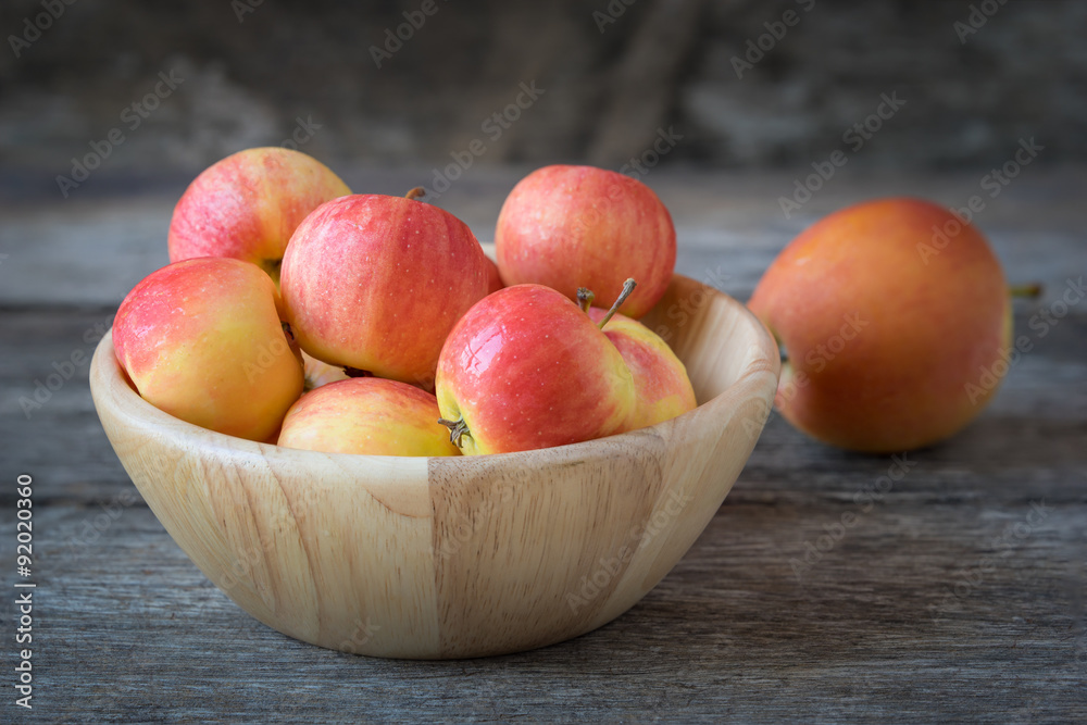 Apples in a wood bowl on wooden background. Apples in a wood bowl on wooden background.