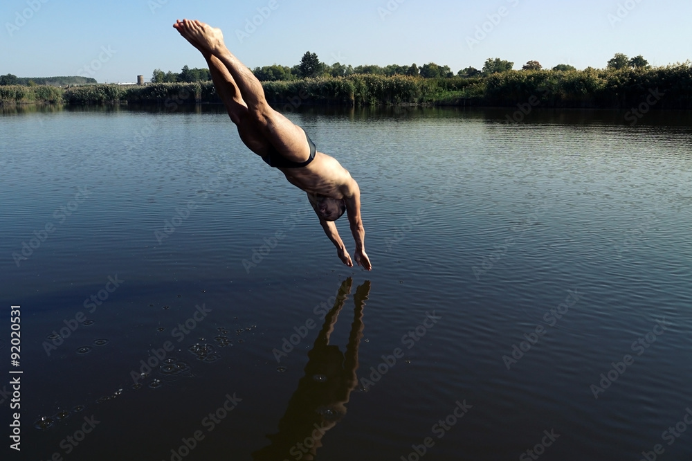 Young man diving into swimming