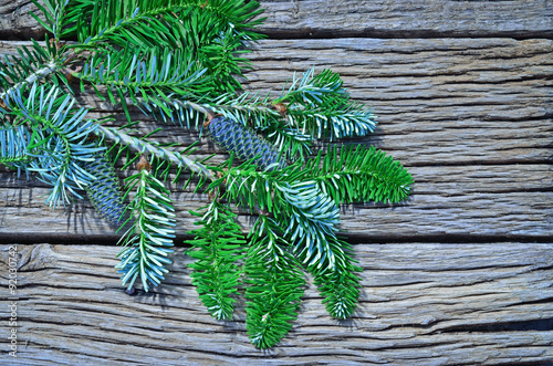  fir cones and branches on wooden background photo