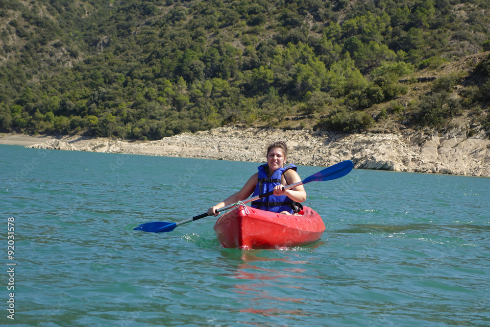 Young woman with a kayak