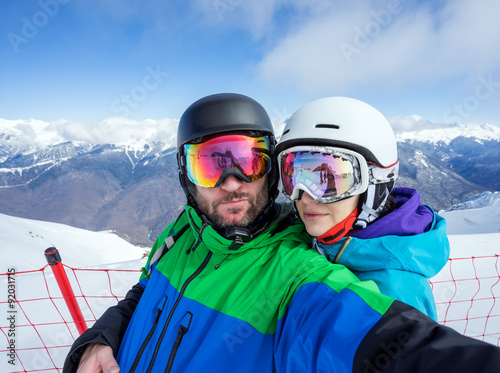 Couple snowboarders doing selfie on camera