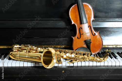 Photography Violin and saxophone on piano background