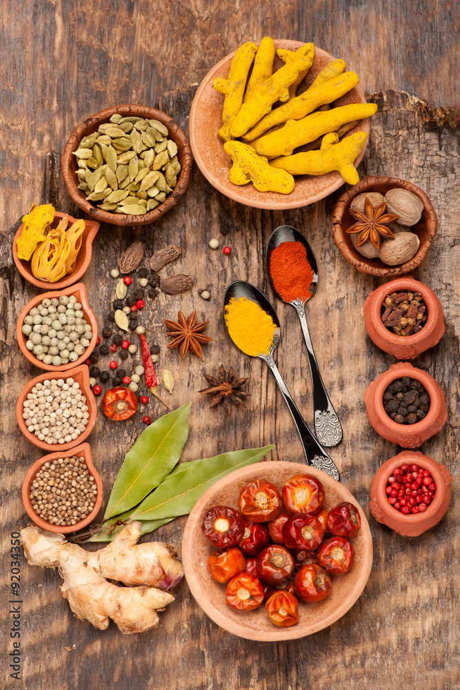 Various spices and spicy on a wooden background. Top view, vertical