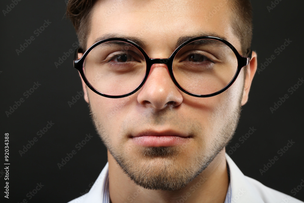 Attractive young man with glasses on gray background Attractive young man with glasses on gray background
