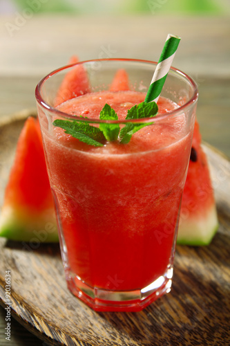 Glass of watermelon juice on wooden table, closeup