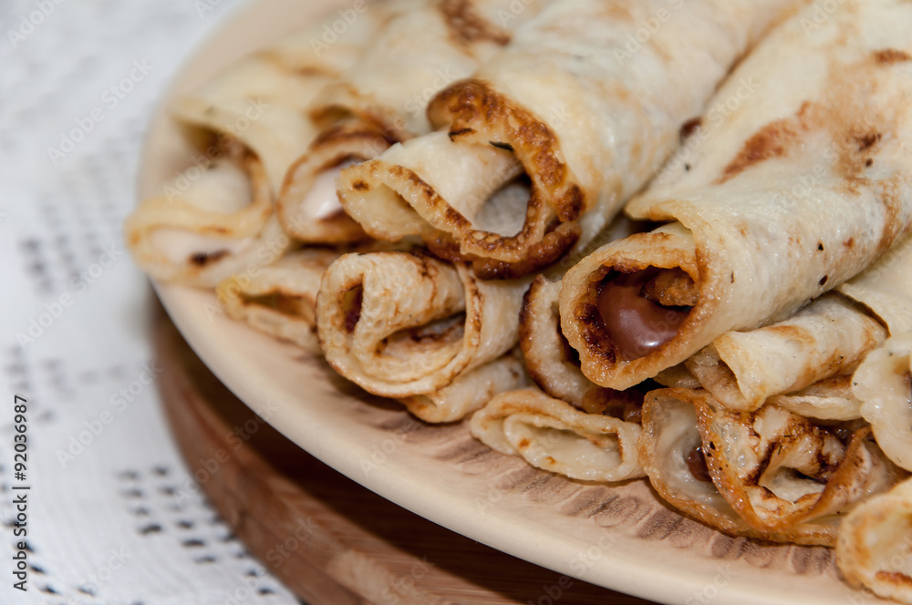 Pancakes stuffed with chocolate cream and served on the plate
