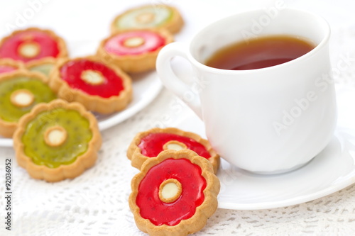 Cup of tea and colorful cookies
