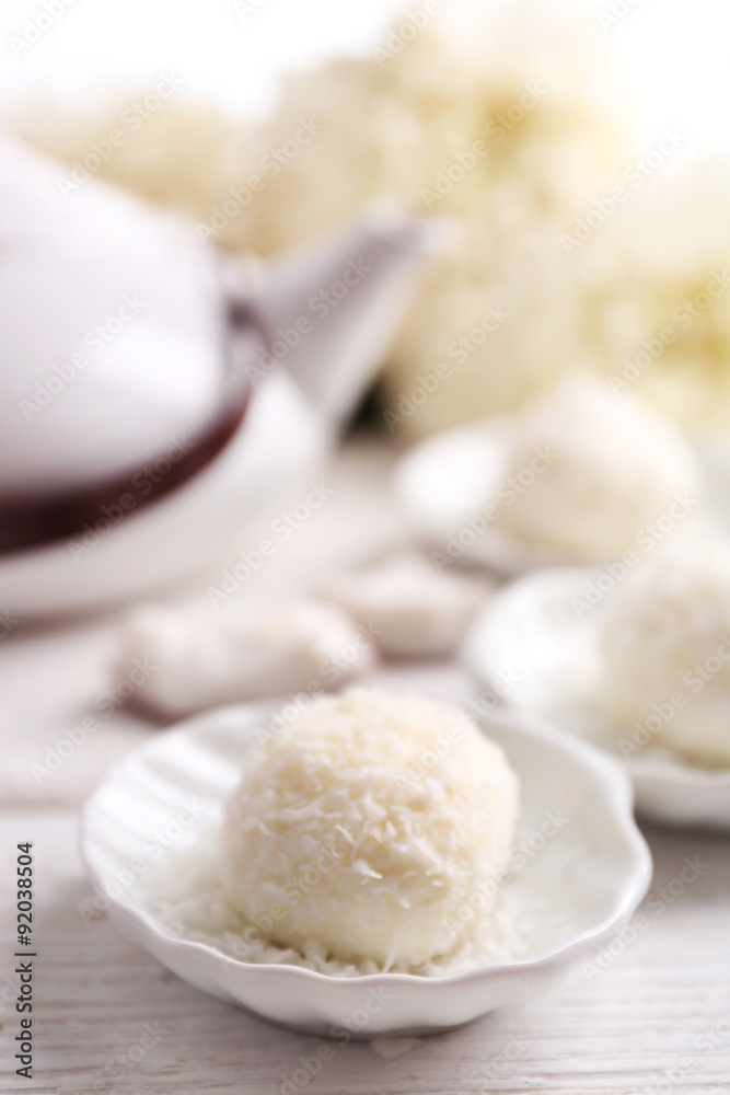 Homemade coco sweets on plate, on light background Homemade coco sweets on plate, on light background