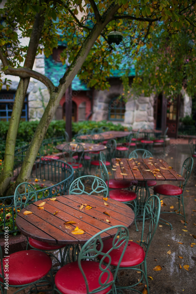 the empty tables in the restaurant autumn background stone house