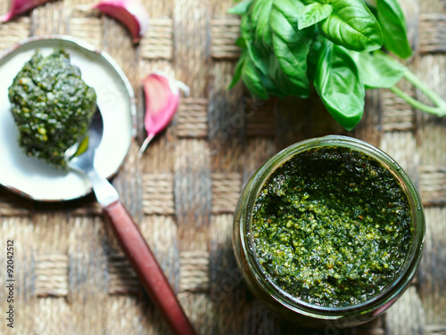 Still life with Italian sauce pesto on rustic background, selective focus