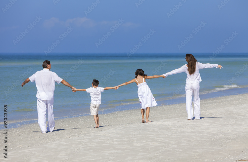 Mother, Father and Children Family Walking on Beach Mother, Father and Children Family Walking on Beach