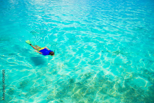 Young man snorkeling in clear tropical turquoise waters