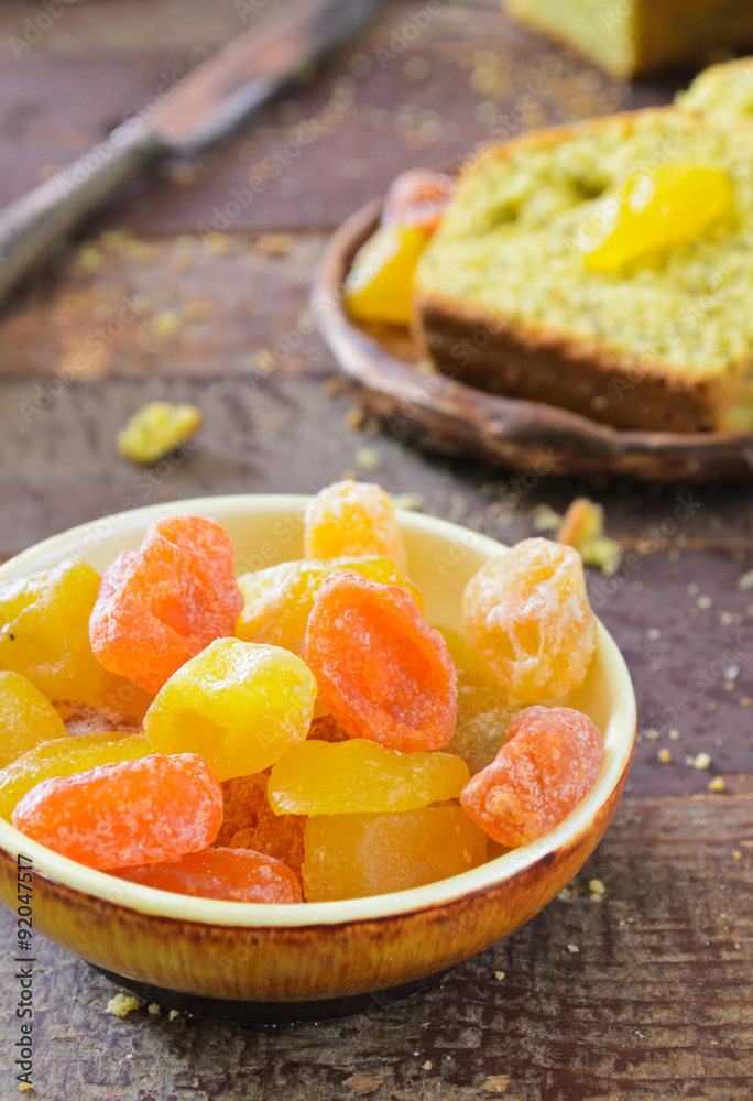 cake with kumquats and poppy seed on wooden background cake with kumquats and poppy seed on wooden background