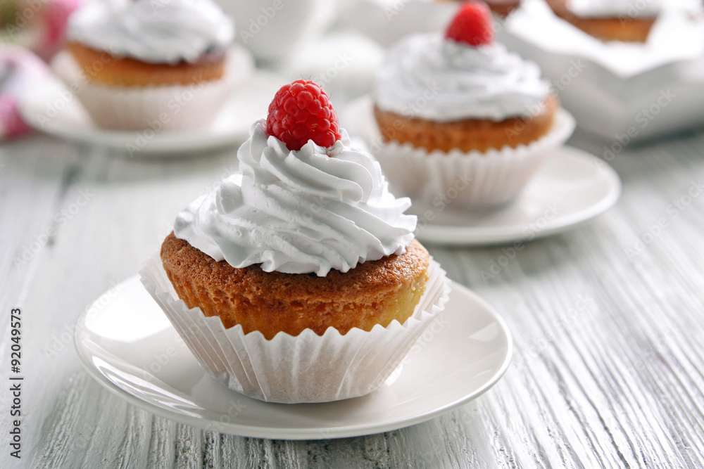 Delicious cupcakes with berries on table close up Delicious cupcakes with berries on table close up