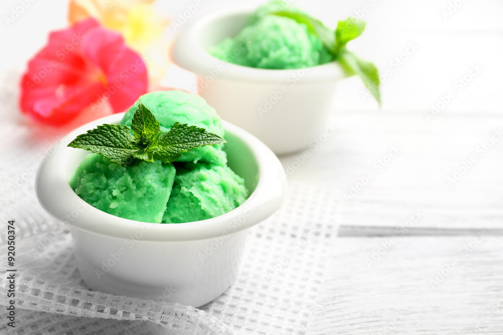 Homemade mint ice-cream on light wooden background Homemade mint ice-cream on light wooden background