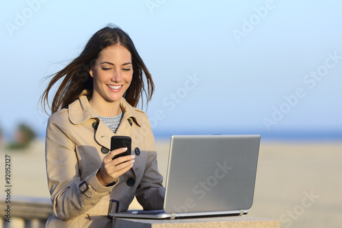 Self employed woman working outdoors on the phone