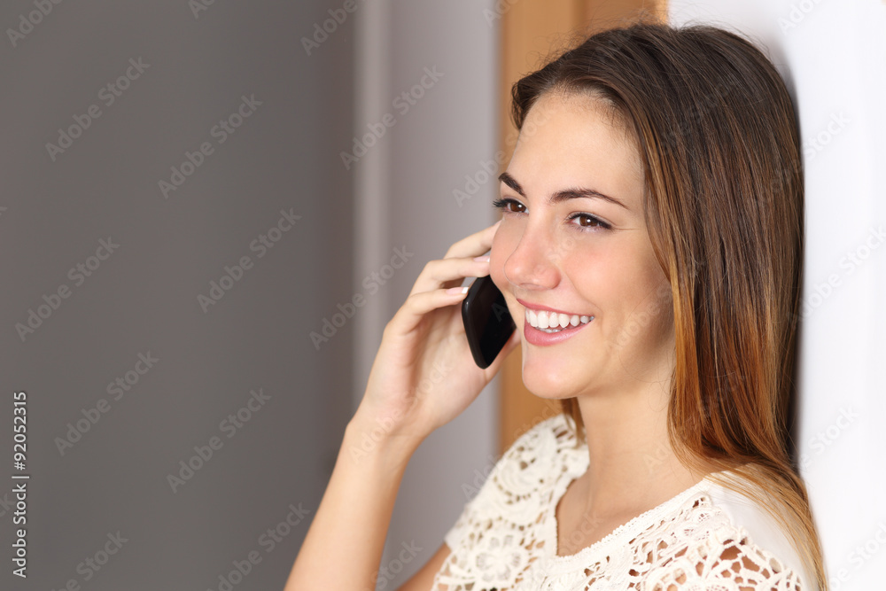 Woman talking on the mobile phone at home or office Woman talking on the mobile phone at home or office