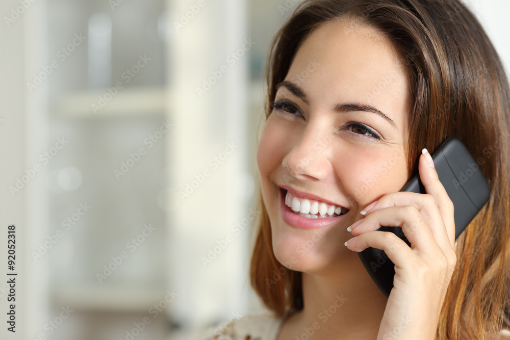 Woman talking on the mobile phone at home Woman talking on the mobile phone at home