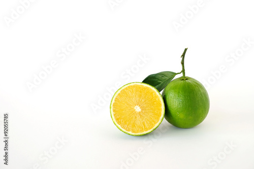 Whole and half sweet oranges on white background