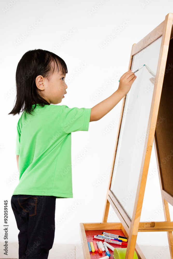 Chinese little girl writing on whiteboard Chinese little girl writing on whiteboard