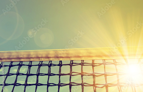 Tennis net with sunset sky in the background
