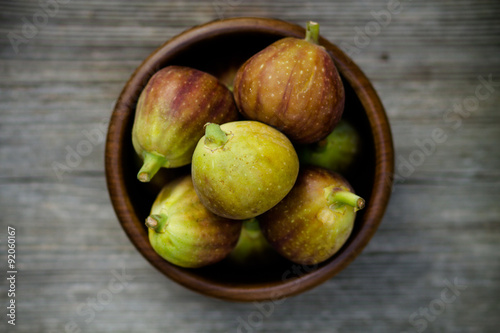 group of figs in a bowl - rustic wooden table