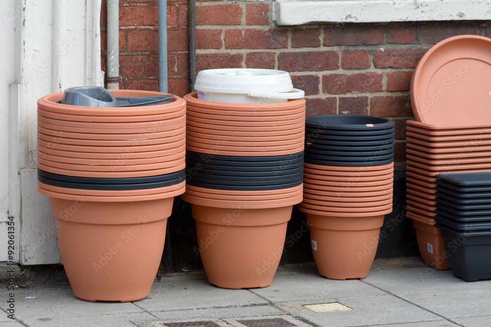 Stacks of plastic flower pots for sale outside shop Stacks of plastic flower pots for sale outside shop