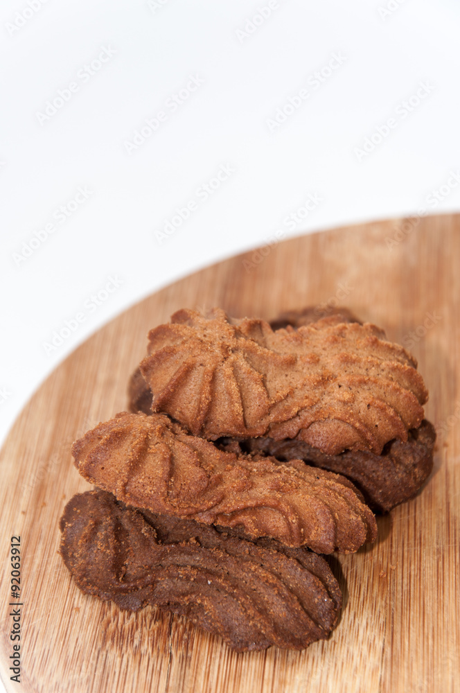 Brown chocolate cookies on the wooden board Brown chocolate cookies on the wooden board