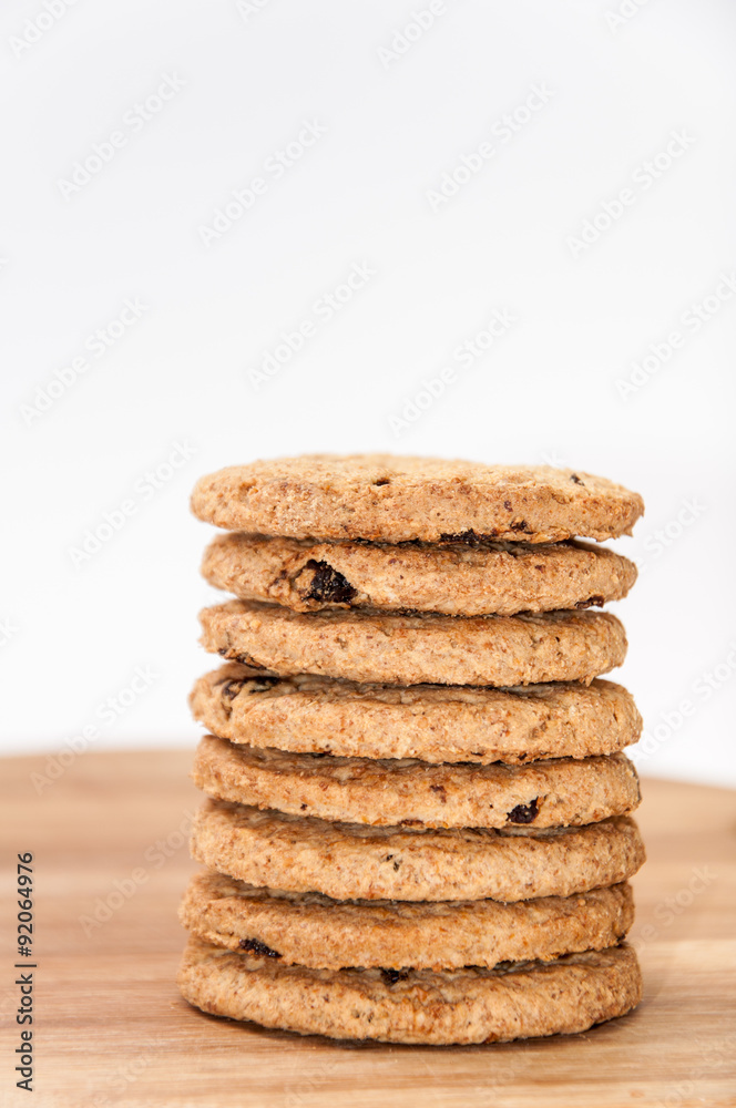 Pile of integral biscuits on a wooden board Pile of integral biscuits on a wooden board