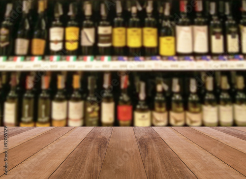 wood floor and wine Liquor bottle on shelf - Blurred background