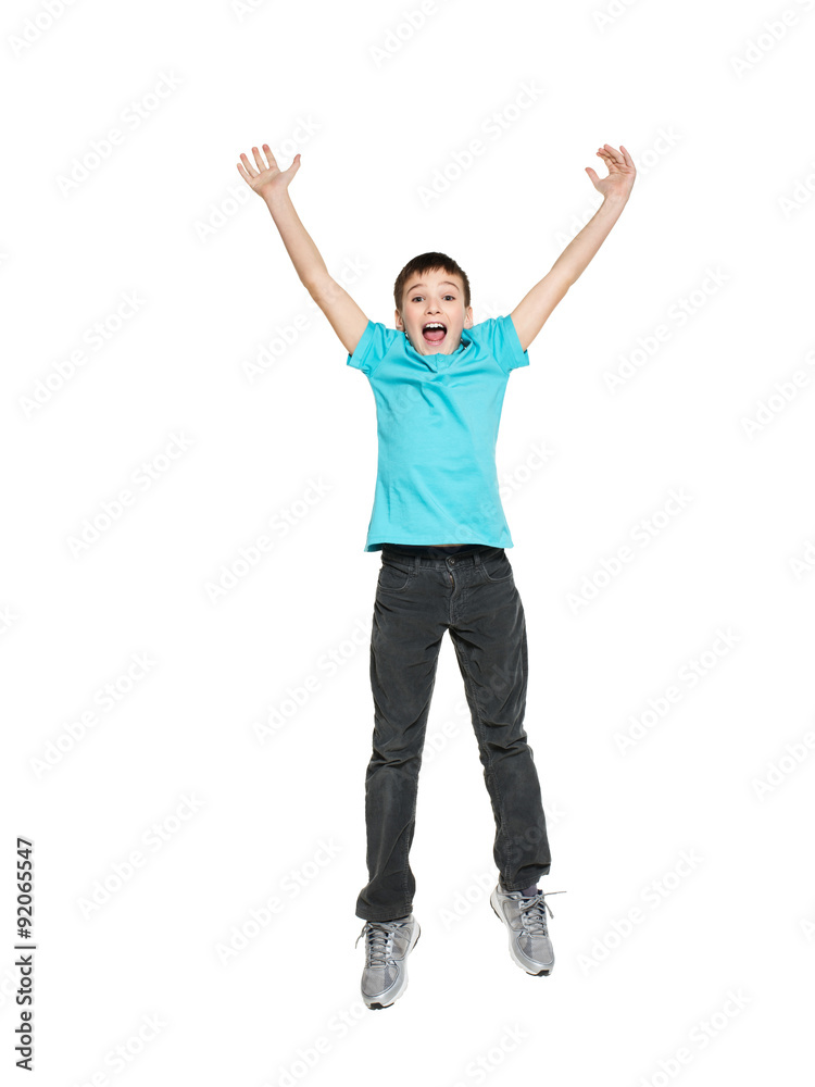 Happy teen boy jumping with raised hands up