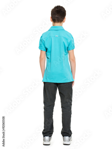 portrait of teen boy standing back in casuals