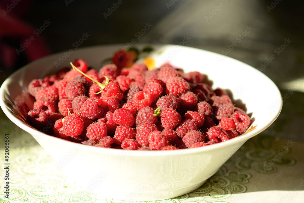 ripe raspberries on a plate light ripe raspberries on a plate light