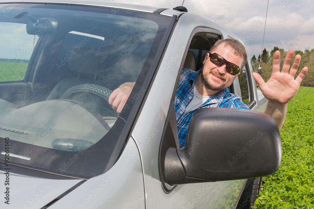 Naklejka premium Man sitting in a car