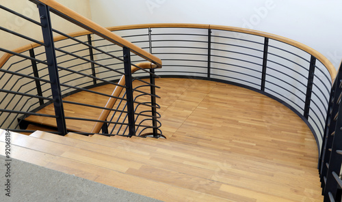 wood and steel stairway in a modern building with parquet