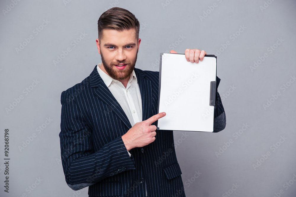 Handsome businessman showing blank clipboard Handsome businessman showing blank clipboard