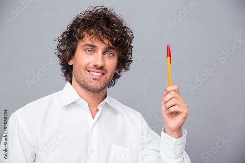 Portrait of a smiling businessman holding pen