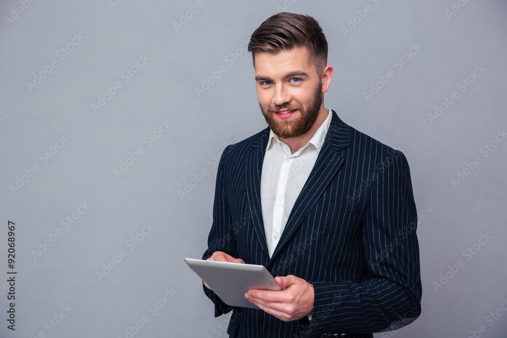 Happy businessman using tablet computer Happy businessman using tablet computer