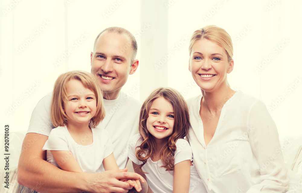 smiling parents and two little girls at home smiling parents and two little girls at home
