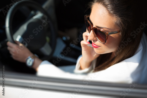 Young businesswoman on the phone in her car