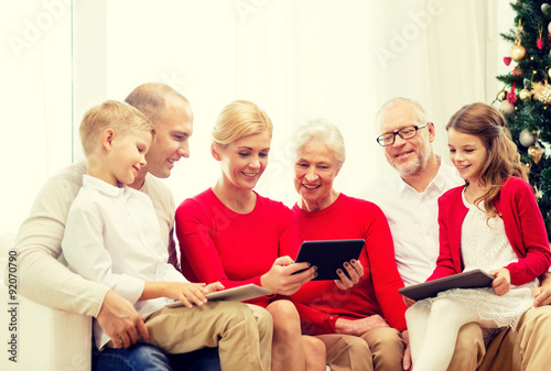 smiling family with tablet pc computers at home © Syda Productions