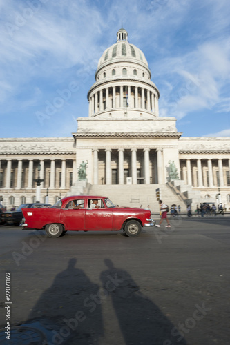 Photography Shadows of pedestrians passing in front of classic American car near the Capitol