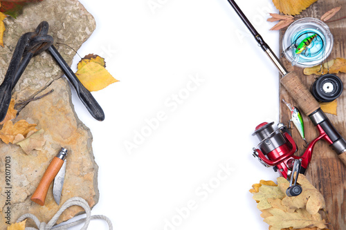 fishing tackles on stones with anchor and leafs