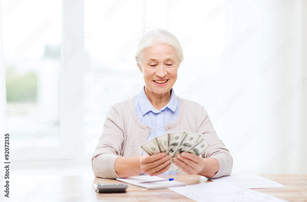 senior woman with money and papers at home senior woman with money and papers at home
