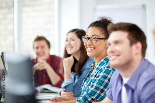 happy high school students in computer class